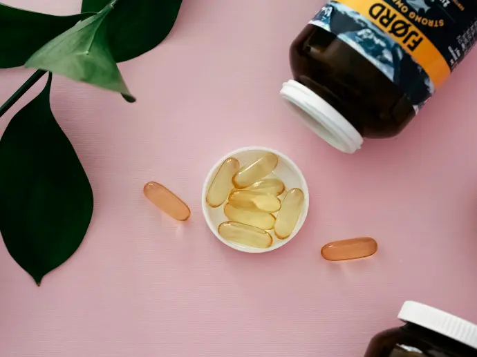 a bowl of pills next to a bottle of pills