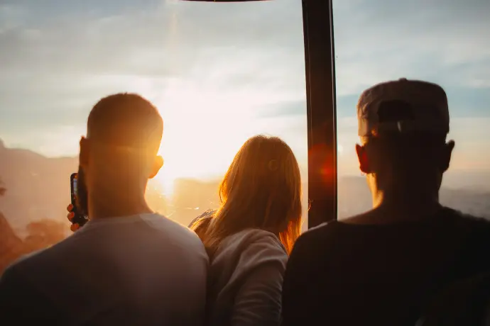 three people standing each other during golden time